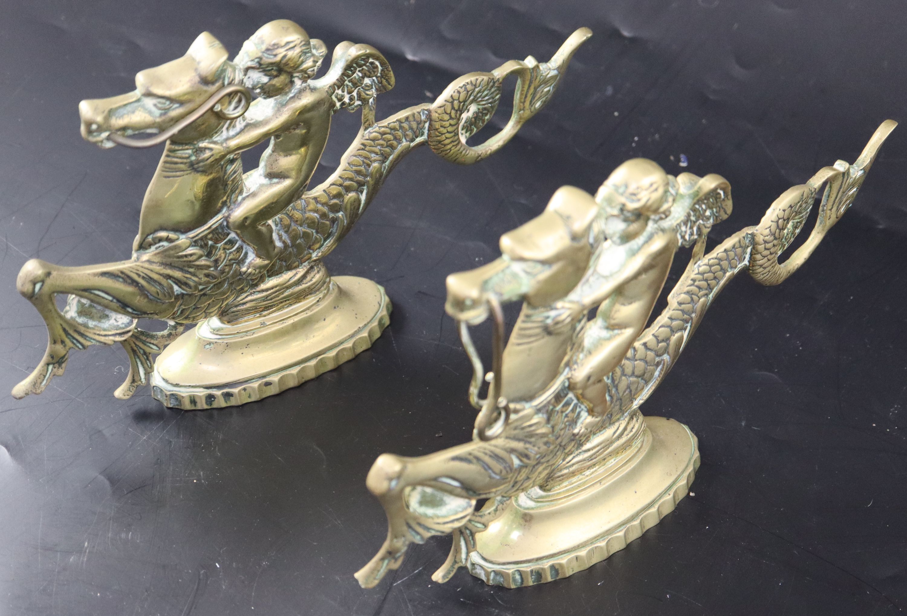 A pair of Venetian brass door stops, width 25cm height 15.5cm